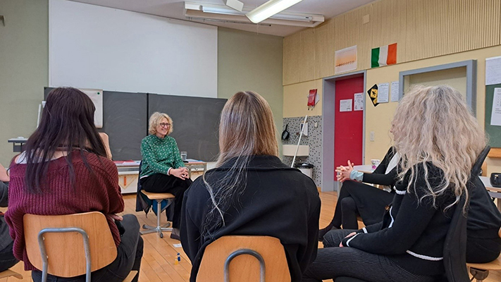 Schulteam sitzt im Schulzimmer mit einer Beratungsperson.